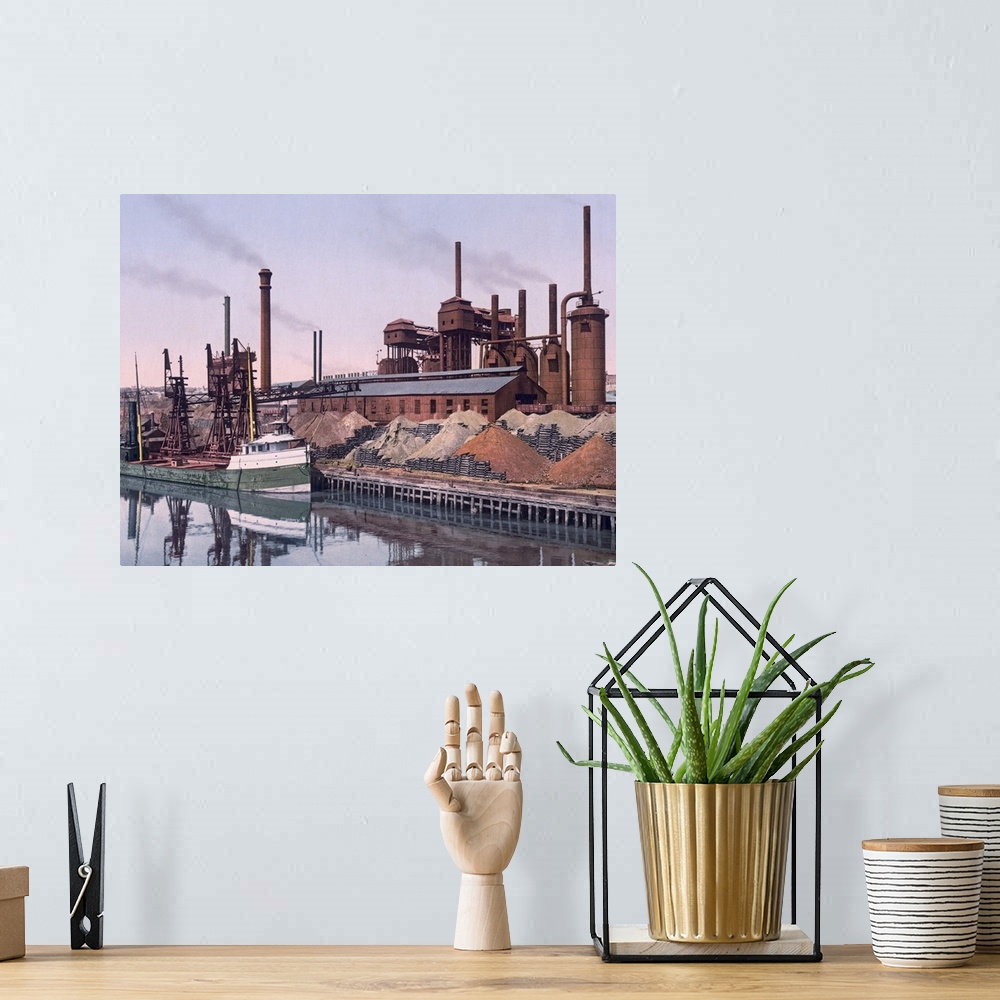 A bohemian room featuring Vintage color photo of an American Steel factory on the banks of a river with tall smoke stacks a...