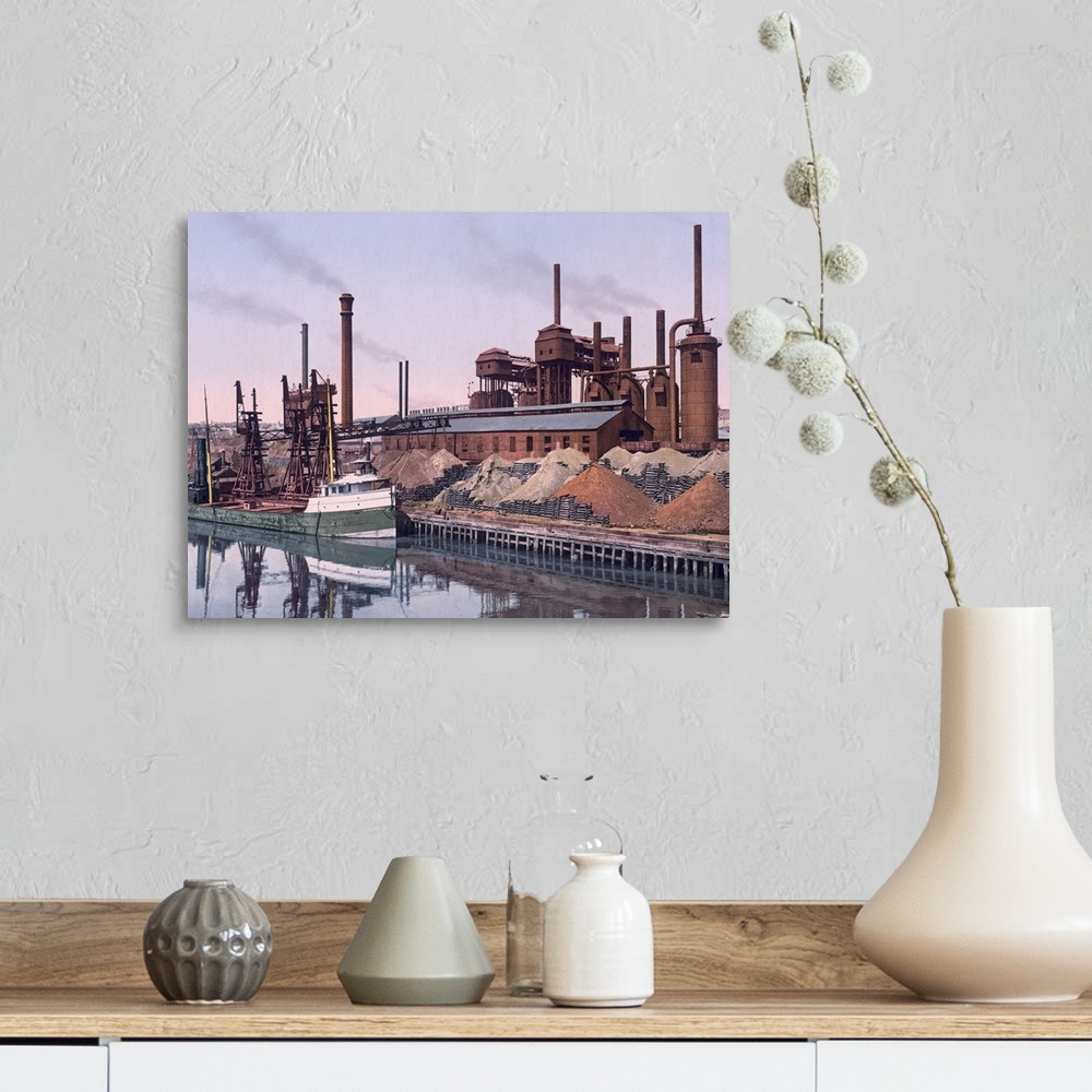 A farmhouse room featuring Vintage color photo of an American Steel factory on the banks of a river with tall smoke stacks a...