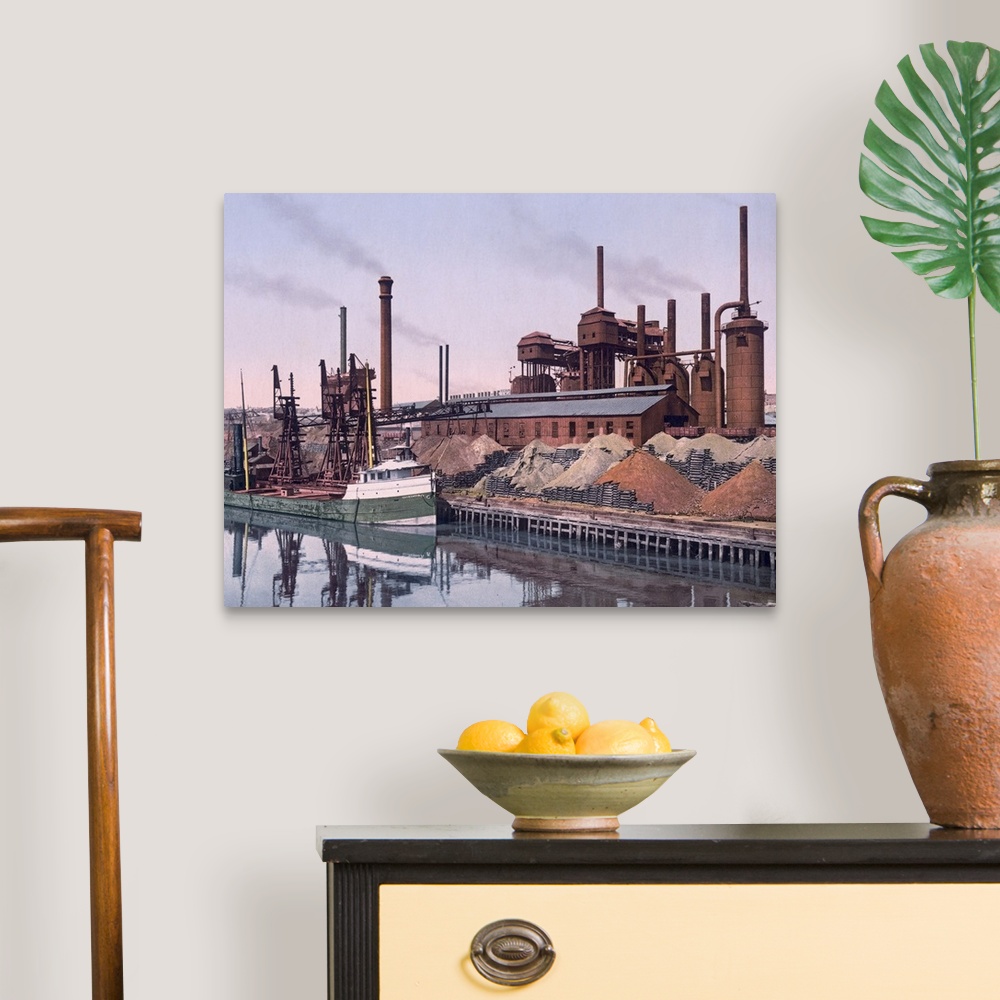 A traditional room featuring Vintage color photo of an American Steel factory on the banks of a river with tall smoke stacks a...