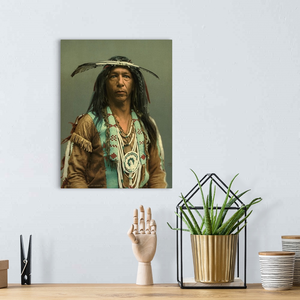 A bohemian room featuring Hand colored photograph of arrow maker, on Ojibwa brave.