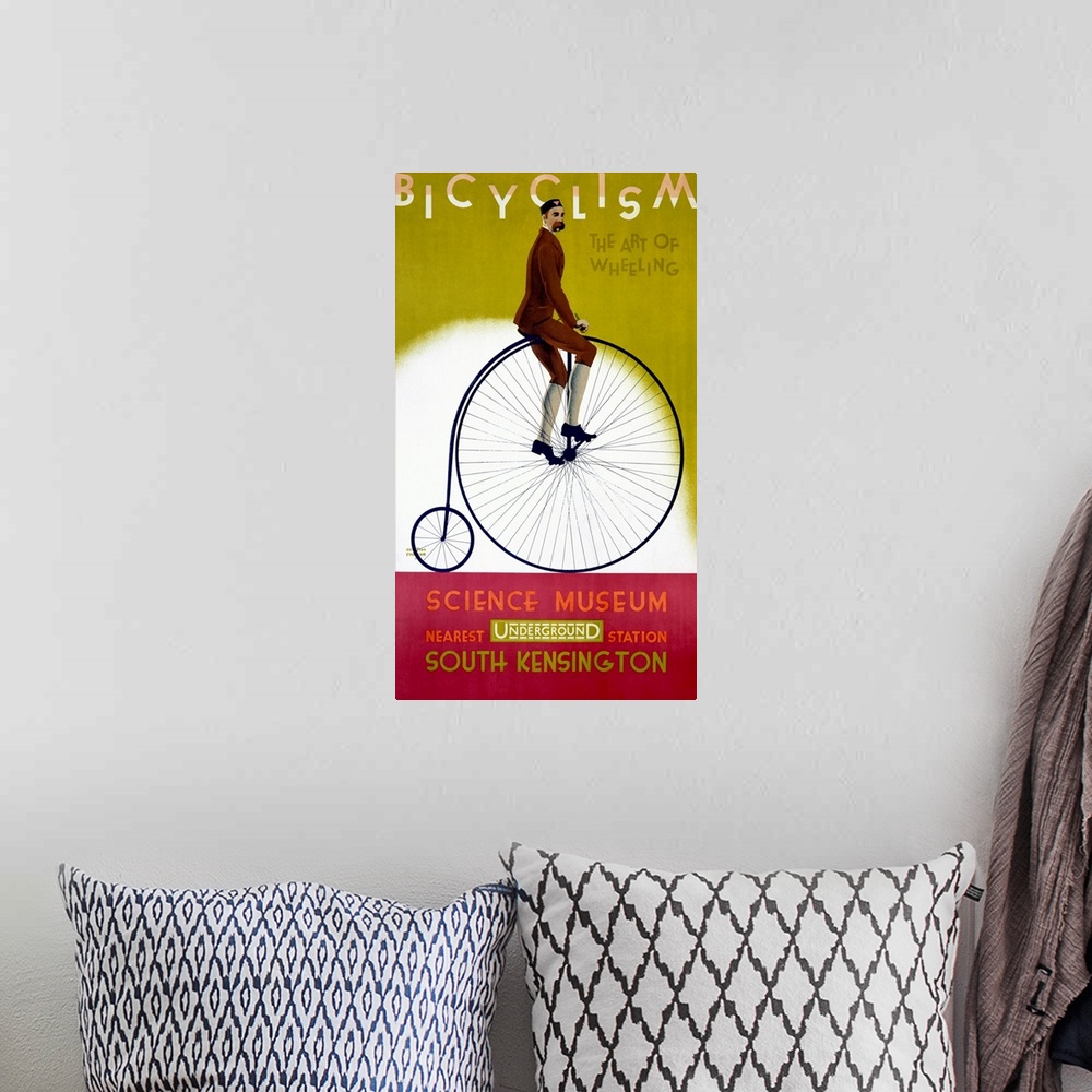A bohemian room featuring This wall art is a vintage advertising poster for an exhibit about bicycles with artwork depictin...