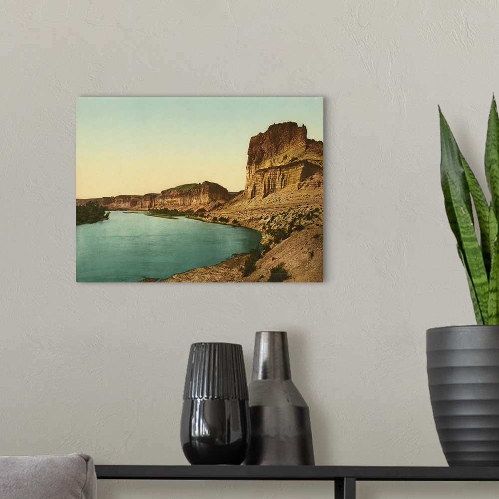 A modern room featuring Hand colored photograph of bluffs of the green river.