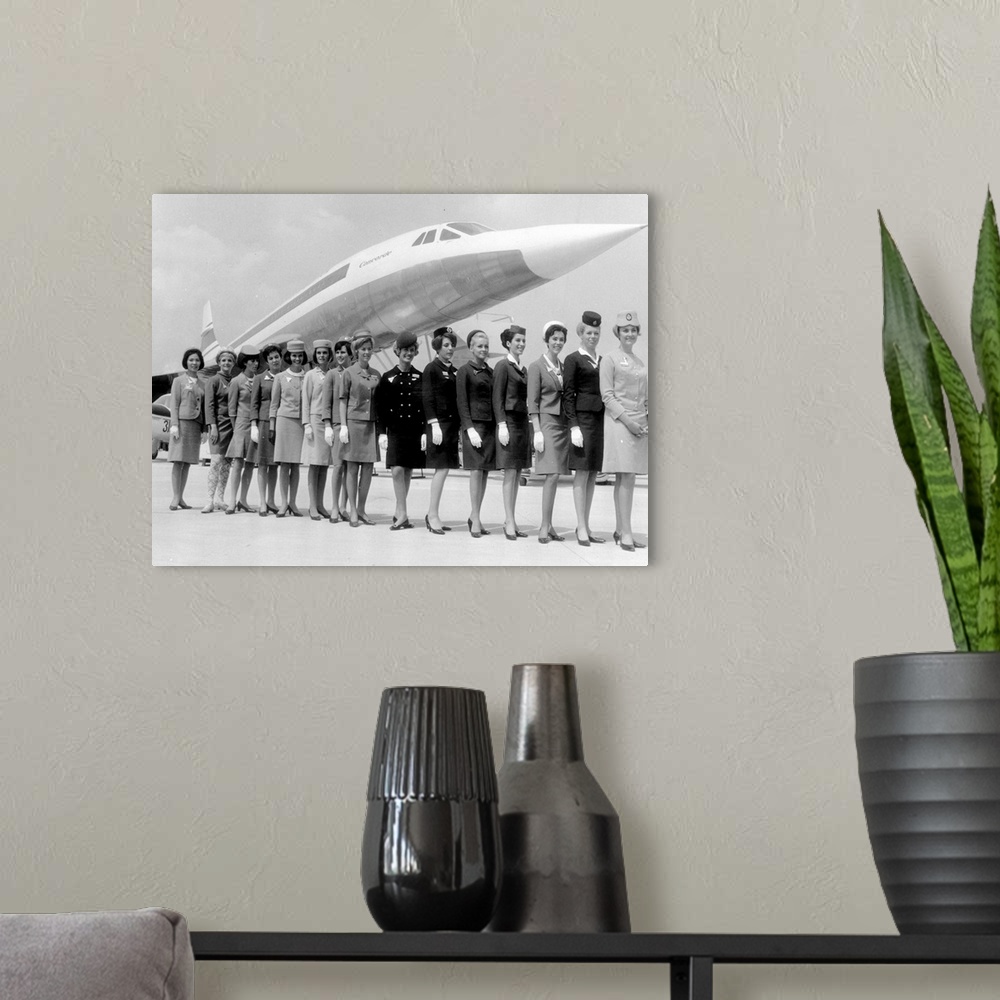 A modern room featuring A line-up of some of the air stewardesses who attend to passengers on board 'Concorde', each one ...