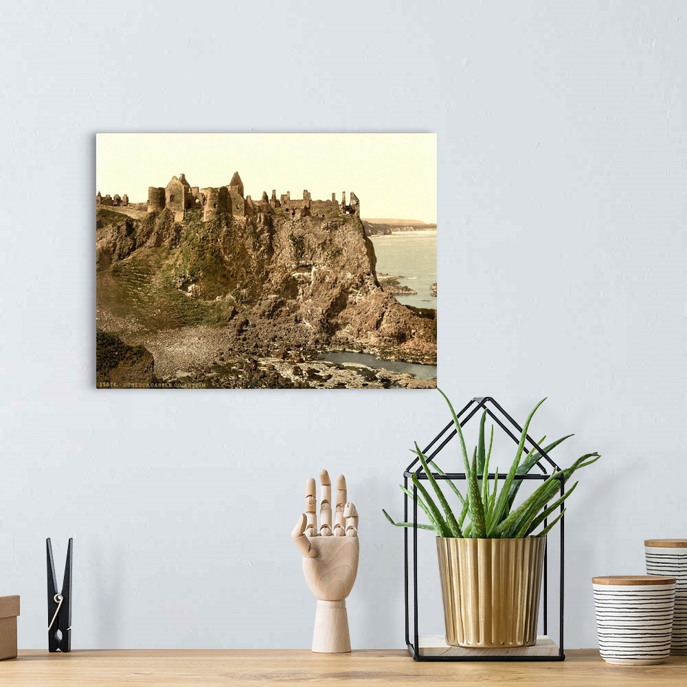 A bohemian room featuring Hand colored photograph of Dunluce castle, country Antrim, Ireland.