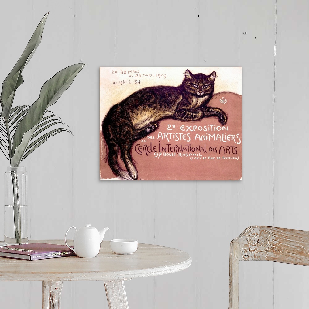 A farmhouse room featuring An antiqued poster with a painting of a cat laying down on canvas.