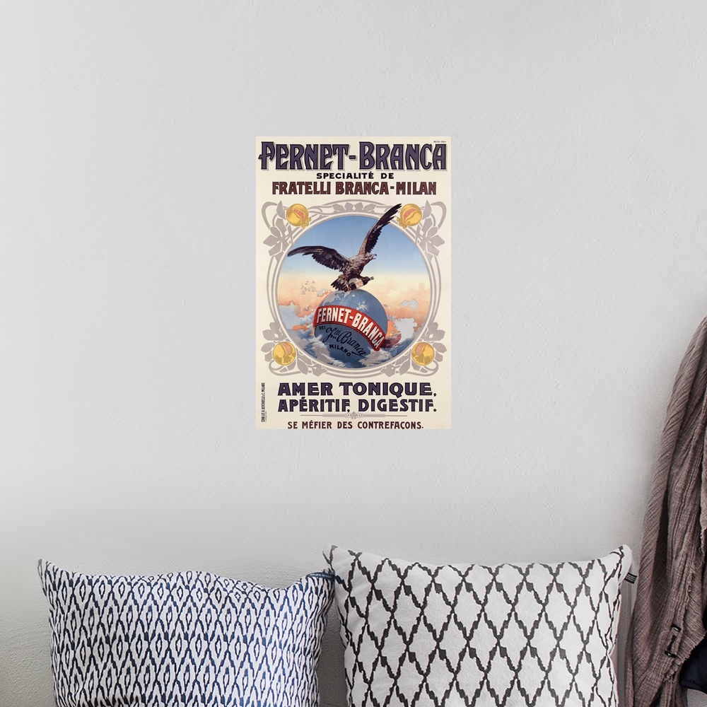 A bohemian room featuring Photograph of old advertising poster featuring an eagle flying over a world globe with a bottle o...