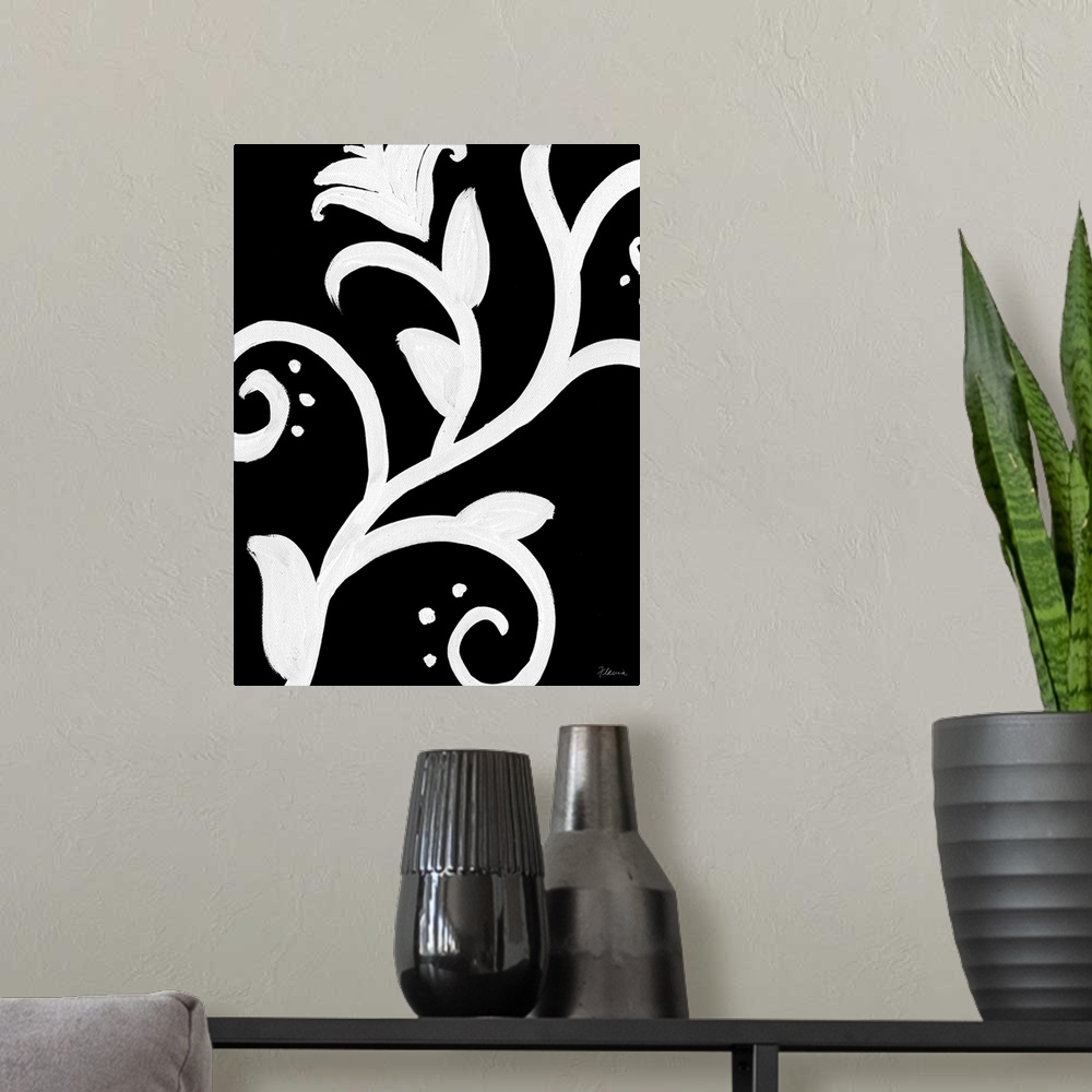 A modern room featuring Wall art of the outlines of curving flowers painted on top of a dark background.