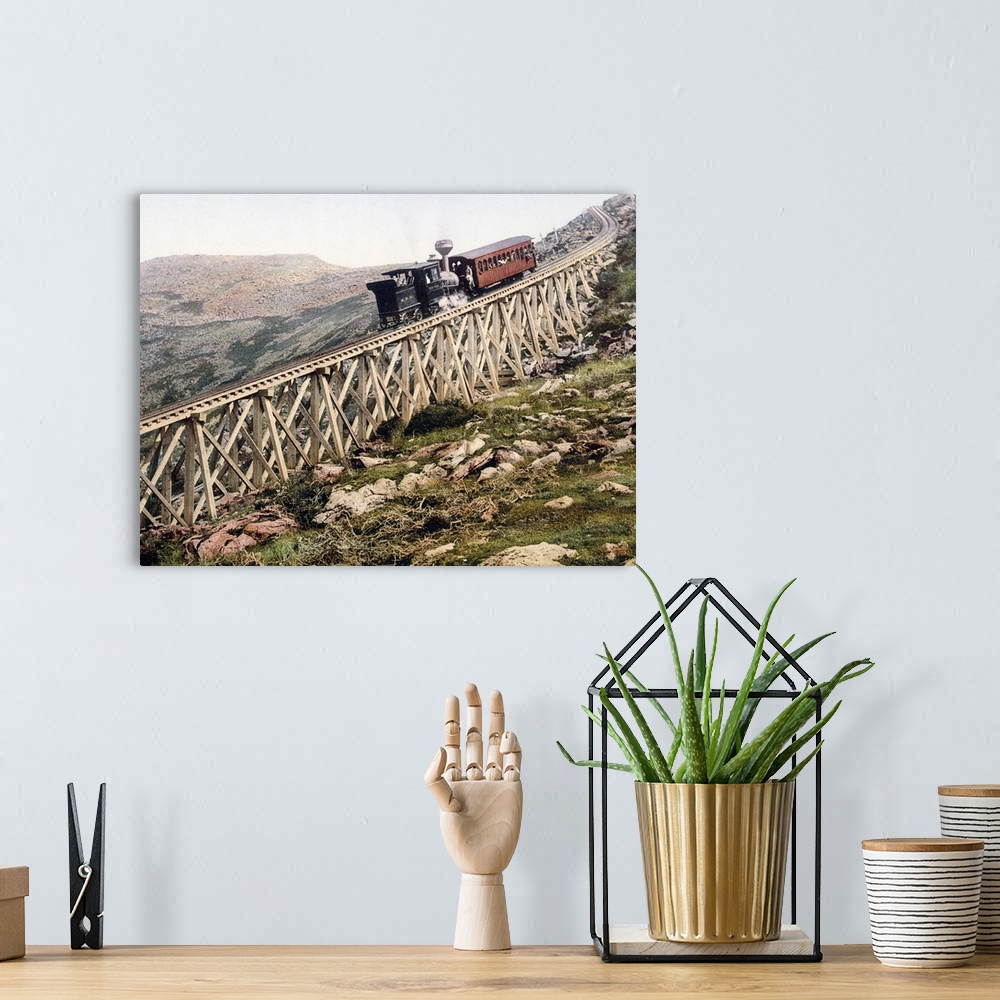 A bohemian room featuring A locomotive pushes a passenger car up a wood railway to the top of a mountain in this vintage la...
