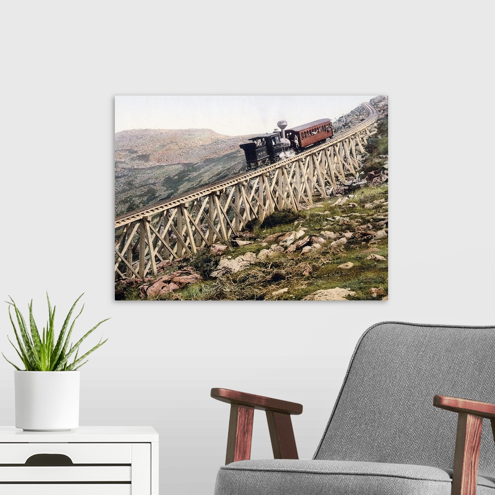 A modern room featuring A locomotive pushes a passenger car up a wood railway to the top of a mountain in this vintage la...