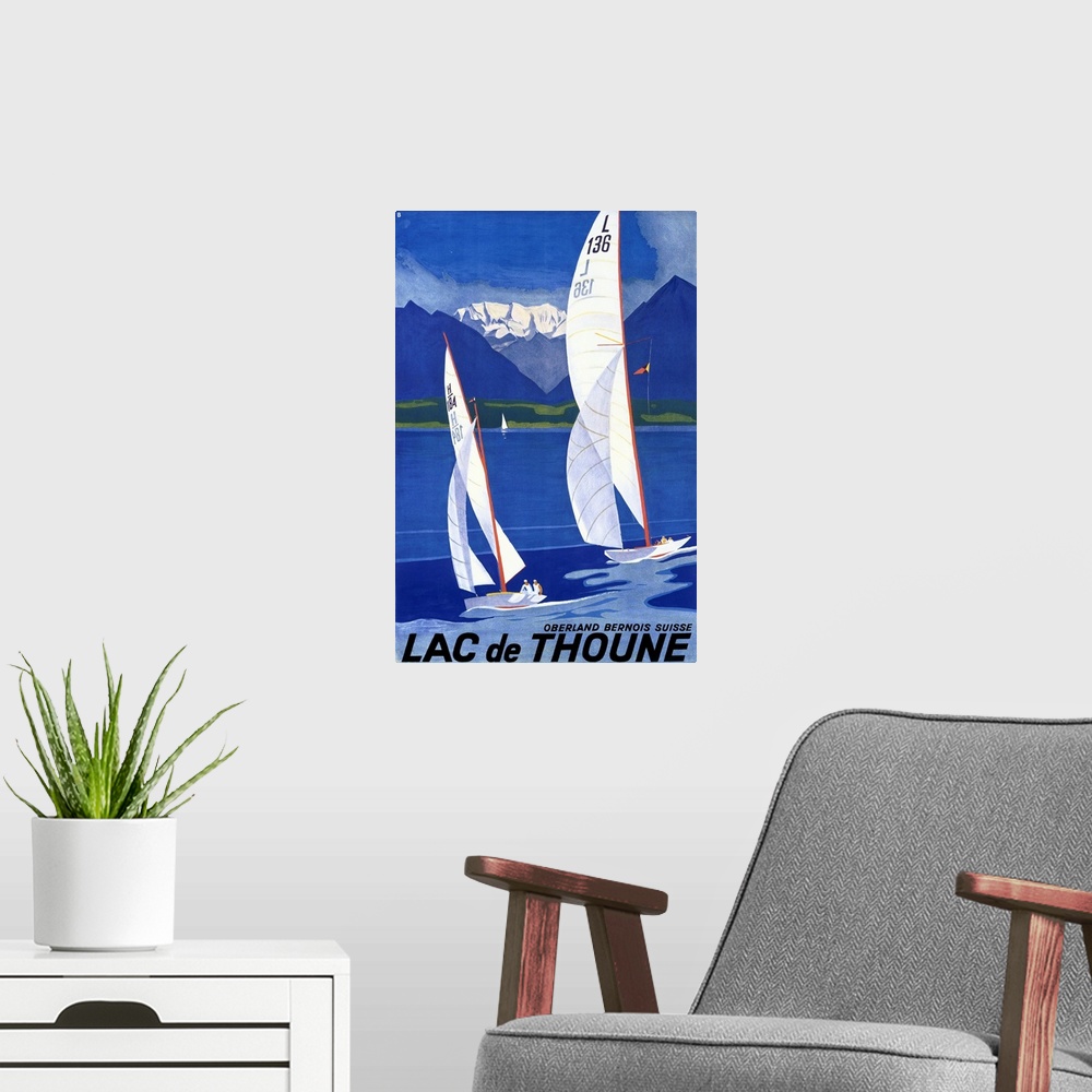 A modern room featuring Old advertising poster artwork showing two sailboats racing in the water with golf course and sno...