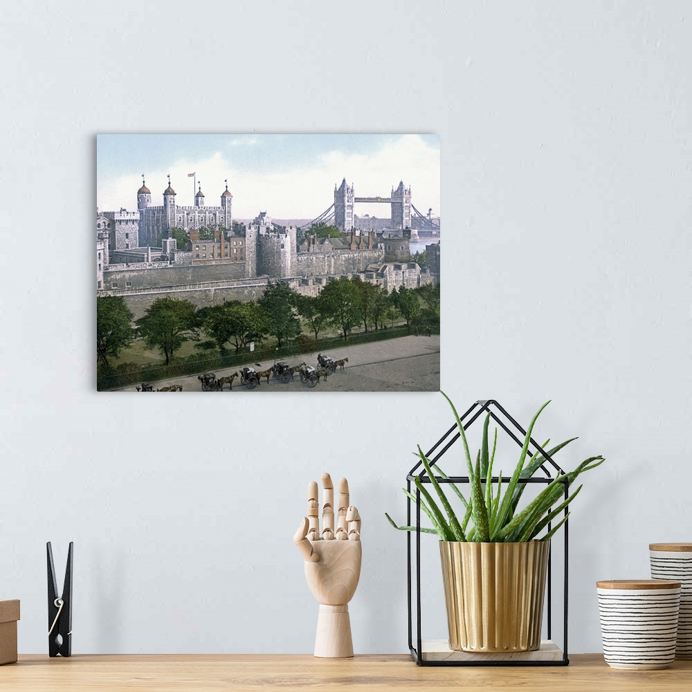 A bohemian room featuring A vintage urban landscape photograph of the Tower of London with horse drawn carts outside that h...