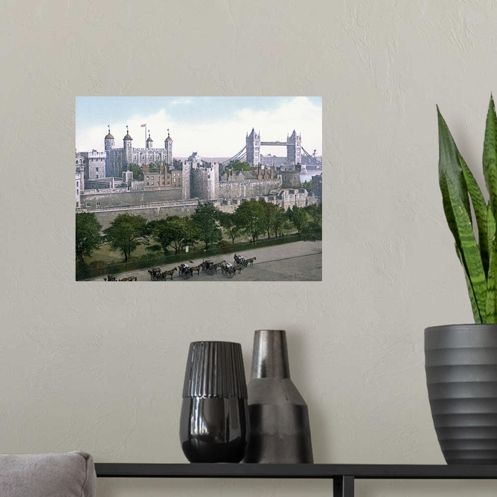 A modern room featuring A vintage urban landscape photograph of the Tower of London with horse drawn carts outside that h...