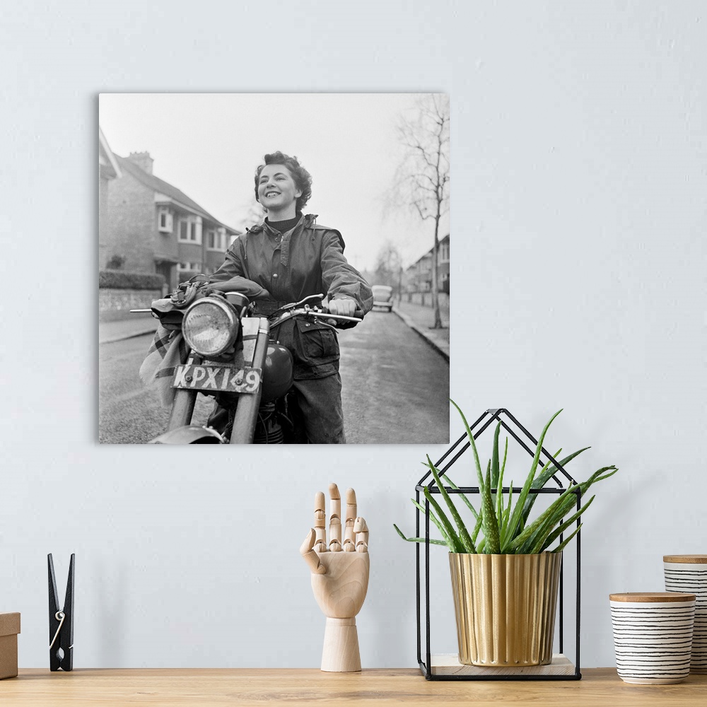 A bohemian room featuring 3rd March 1951:  June Adams, aged 21, on her motorcycle, who competes in motorcycle trials at wee...