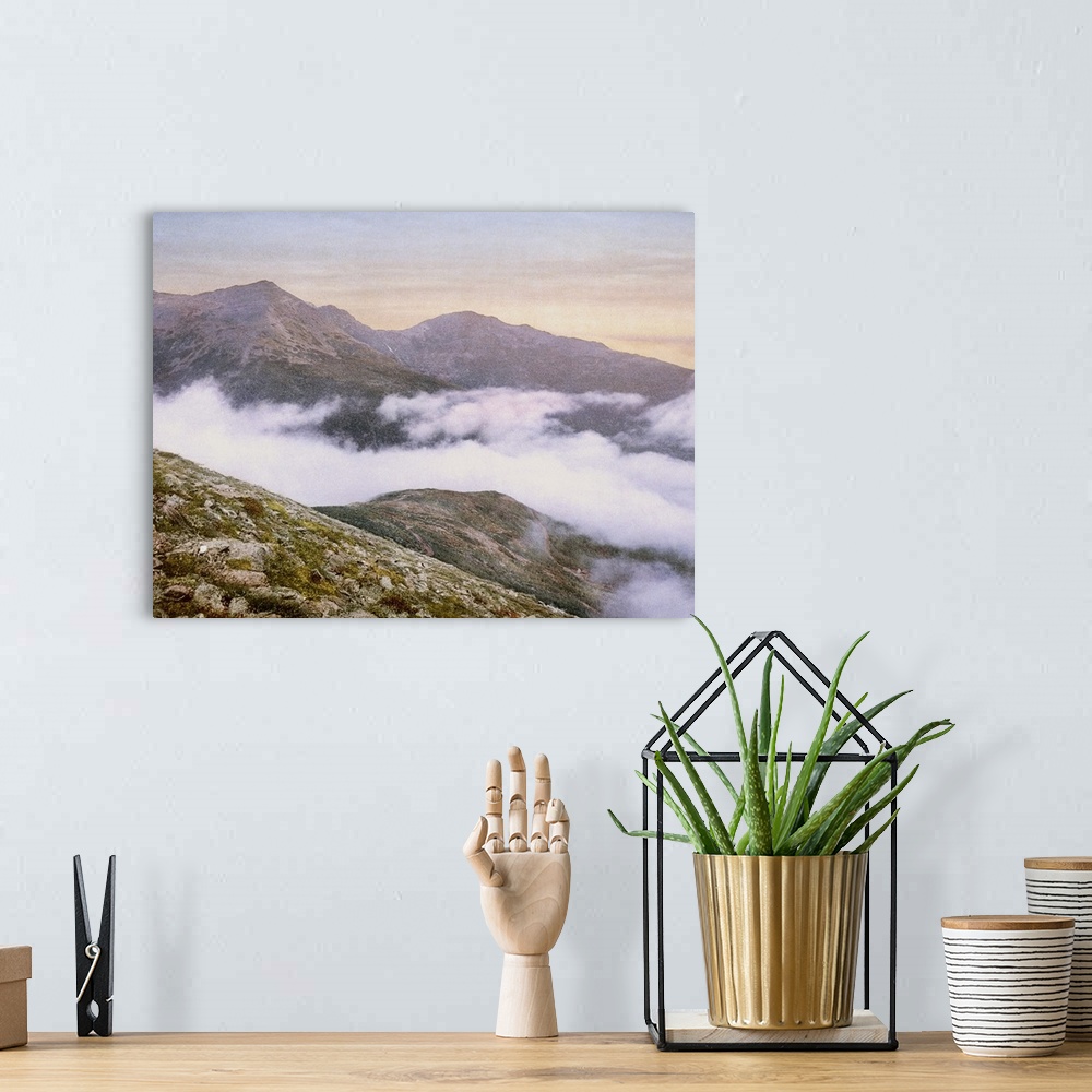 A bohemian room featuring Photograph of mountains peeking through fog.