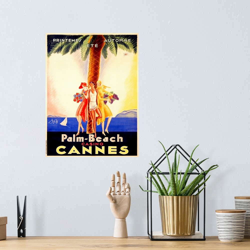 A bohemian room featuring Old stylized travel poster for a casino in France with three women leaning against a palm tree an...