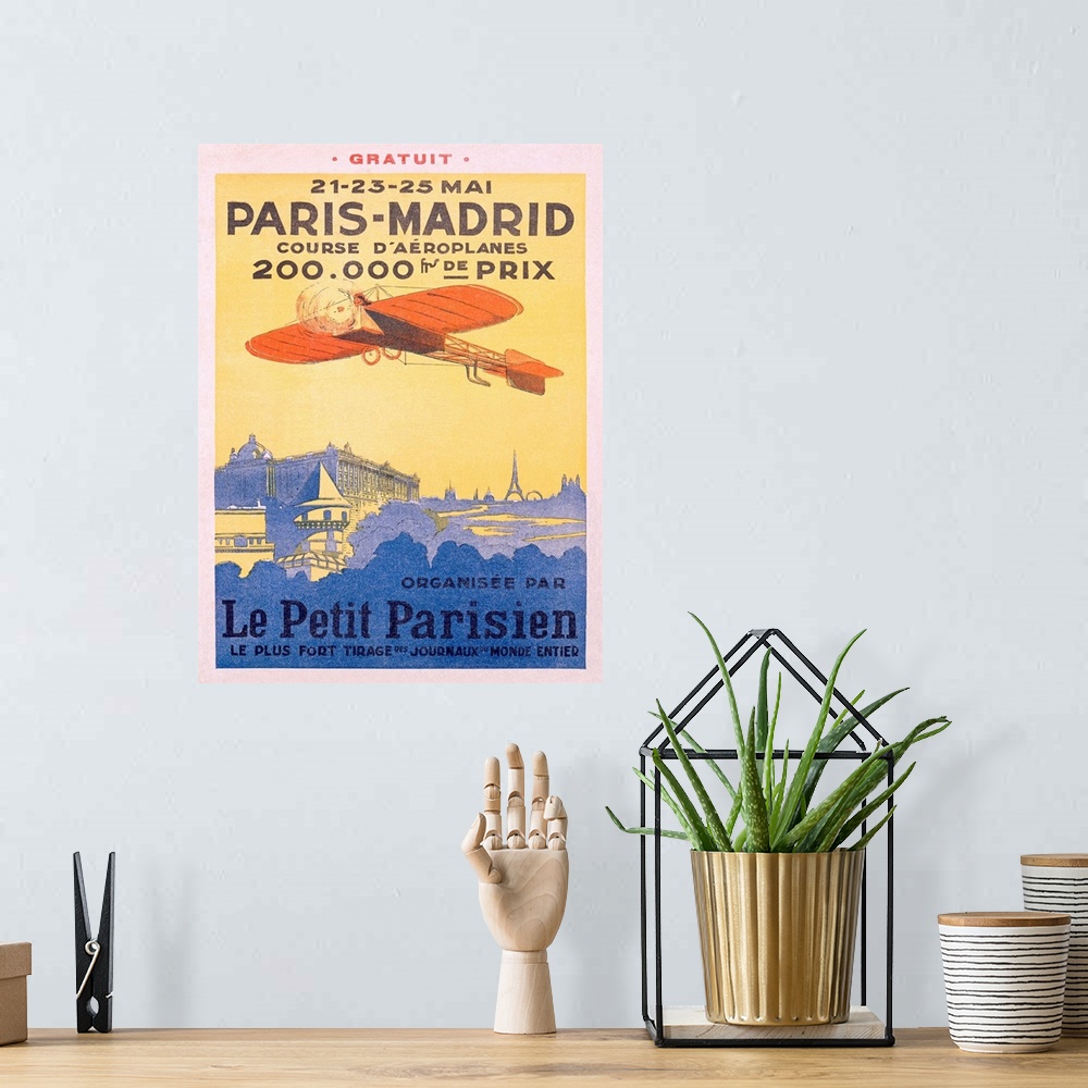 A bohemian room featuring Advertising artwork for an airplane race from France to Spain. The poster shows a propeller plane...