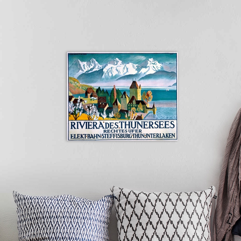 A bohemian room featuring Vintage poster of a small town that sits on the water. Snow topped mountains are drawn in the bac...
