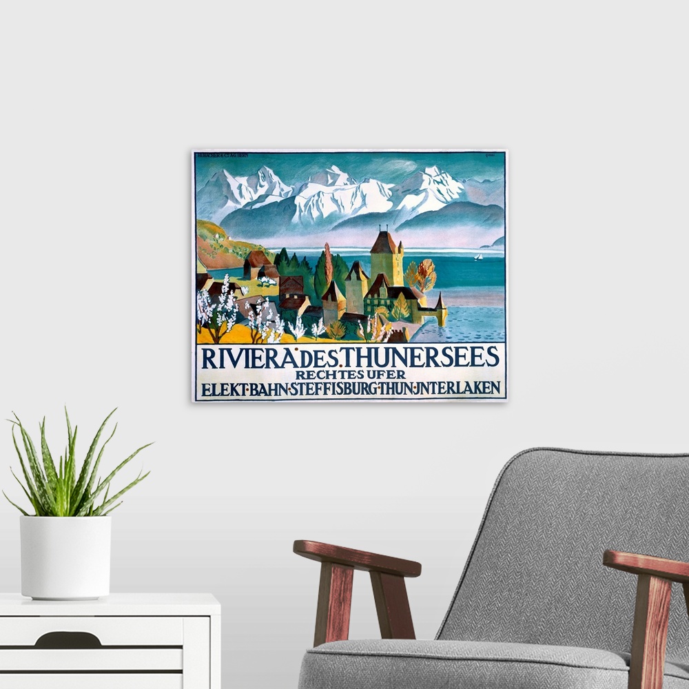 A modern room featuring Vintage poster of a small town that sits on the water. Snow topped mountains are drawn in the bac...