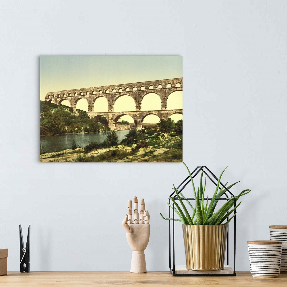 A bohemian room featuring Hand colored photograph of roman bridge over the gardon, constructed by Agrippa, Nimes, France.