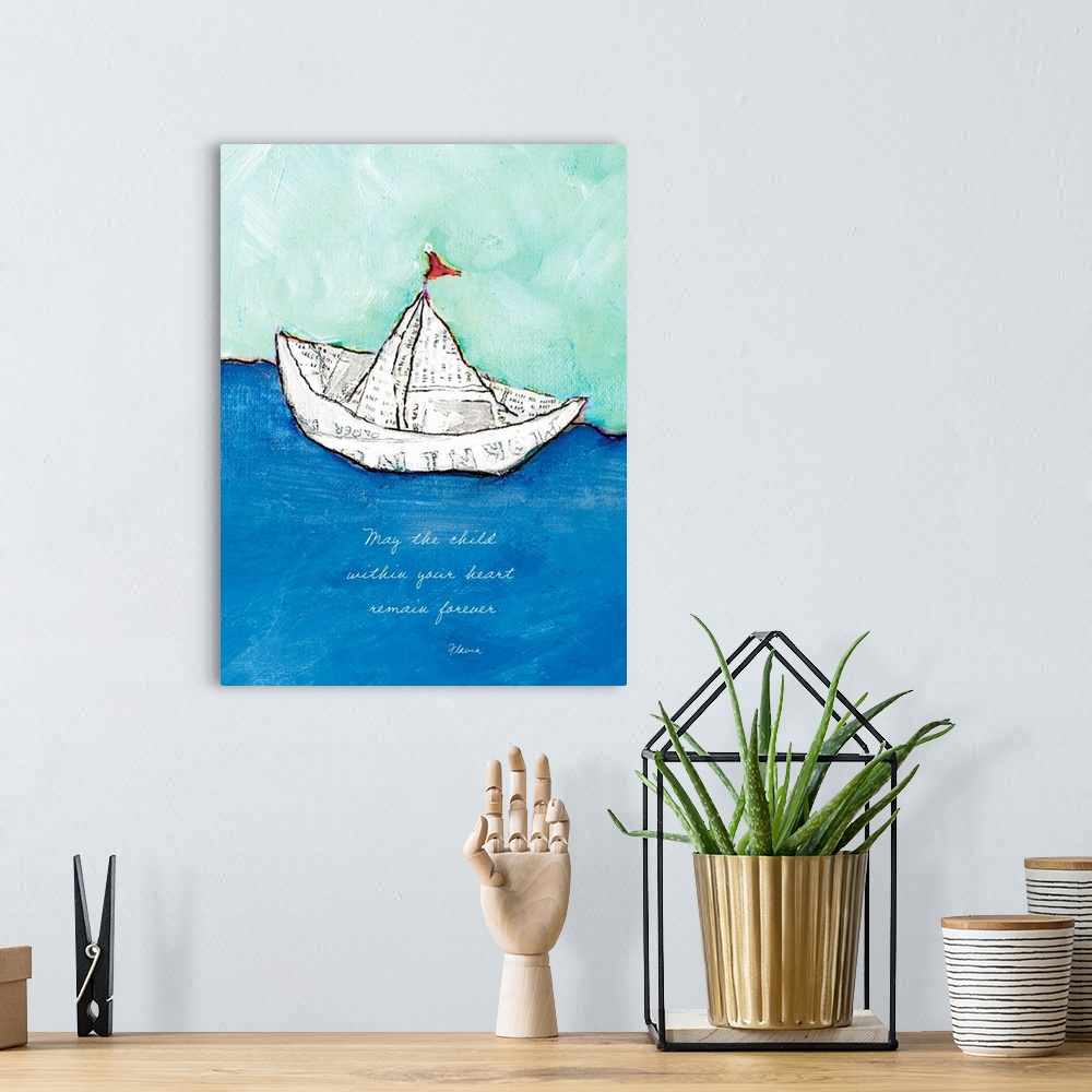 A bohemian room featuring Mixed media artwork of a toy boat made of a sheet of newspaper, with the text ""May the child wit...