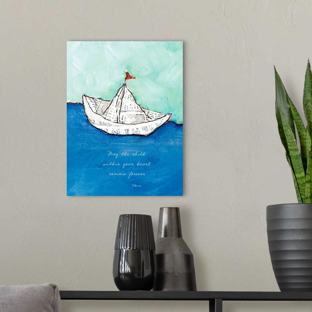 A modern room featuring Mixed media artwork of a toy boat made of a sheet of newspaper, with the text ""May the child wit...