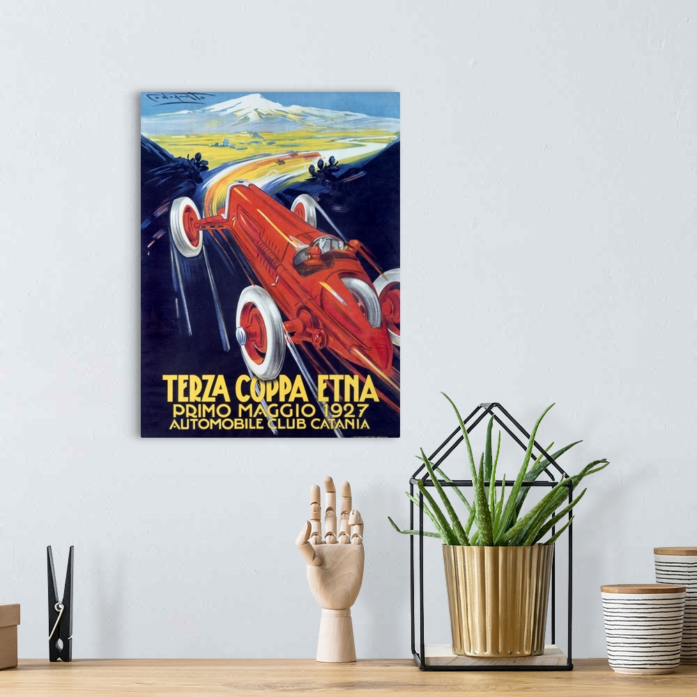 A bohemian room featuring Antique poster advertising a car club.  There is  a classic car racing through mountain roads on ...
