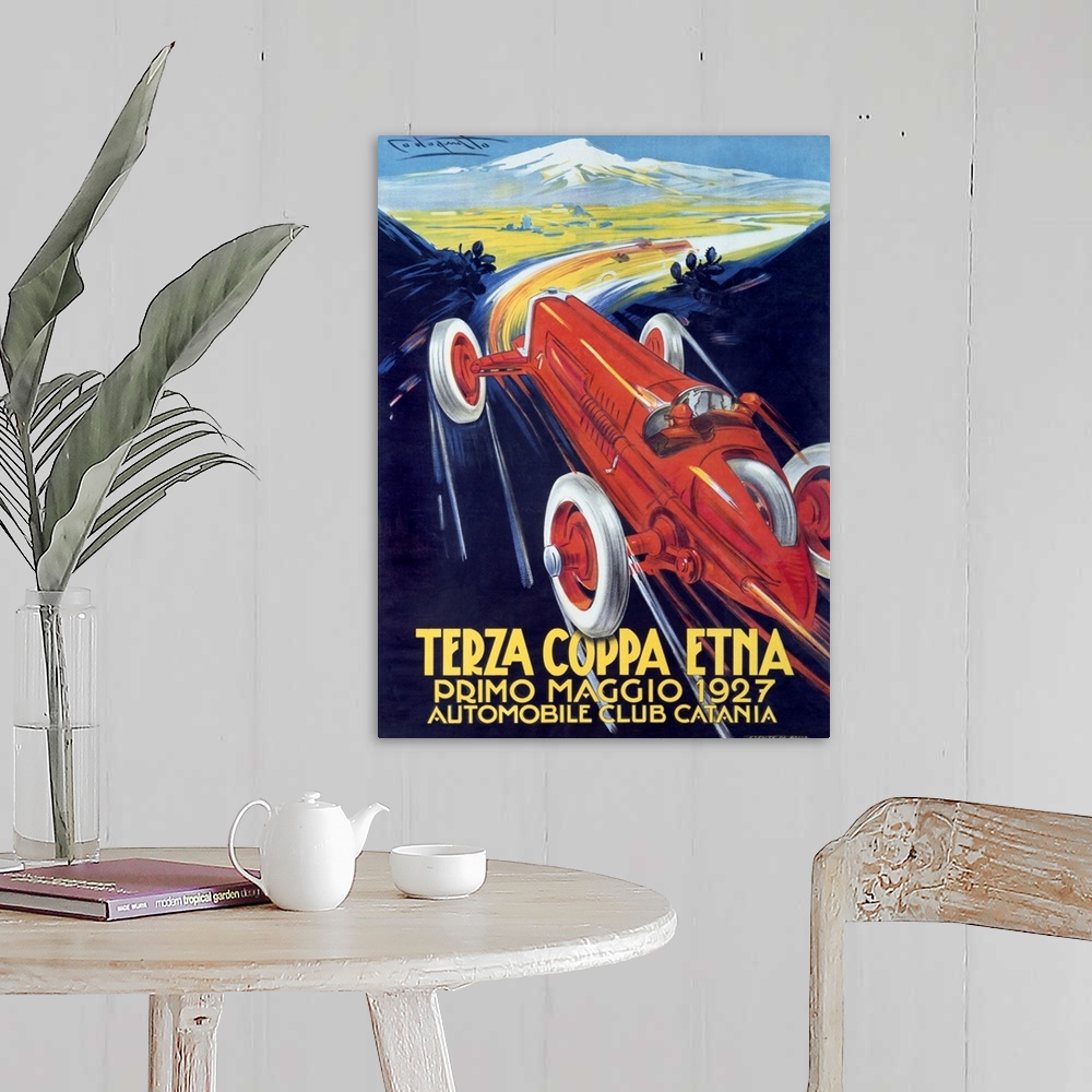 A farmhouse room featuring Antique poster advertising a car club.  There is  a classic car racing through mountain roads on ...