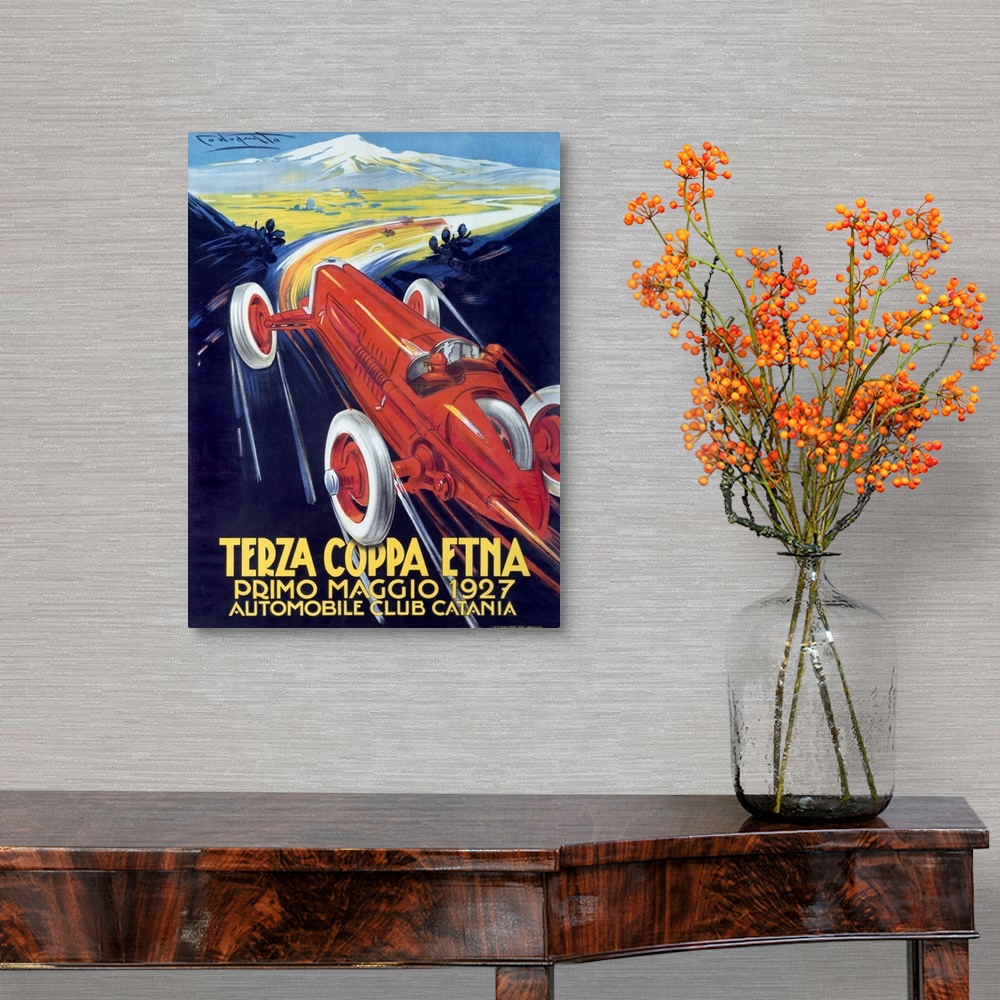 A traditional room featuring Antique poster advertising a car club.  There is  a classic car racing through mountain roads on ...