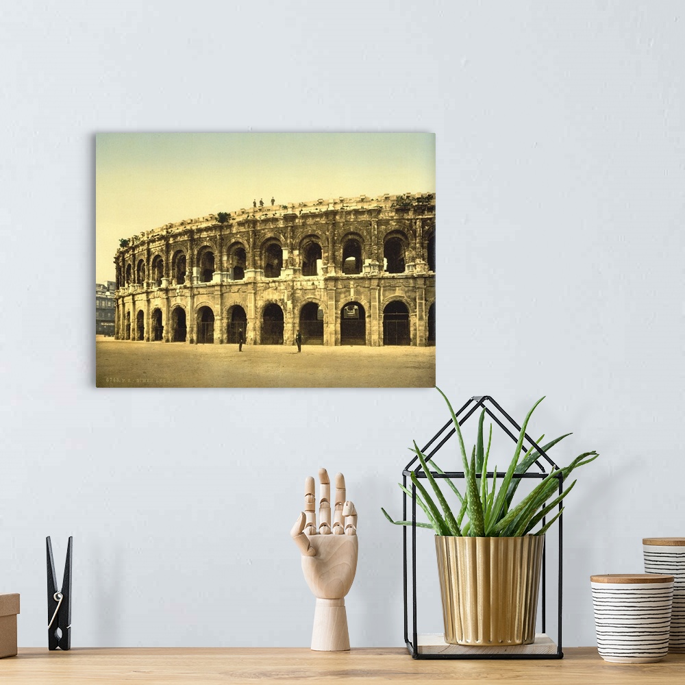 A bohemian room featuring Hand colored photograph of the arena, Nimes, France.