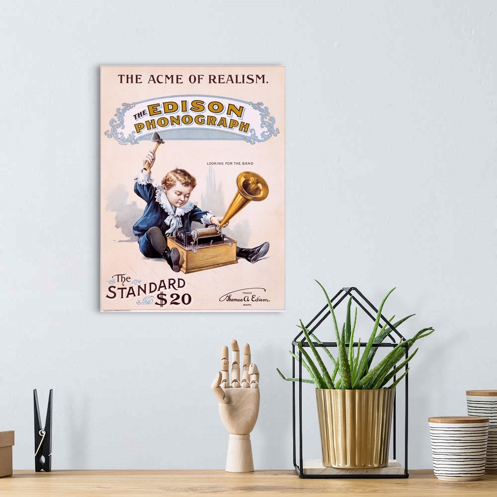 A bohemian room featuring Vintage poster showing a small boy playing with the Edison phonograph.
