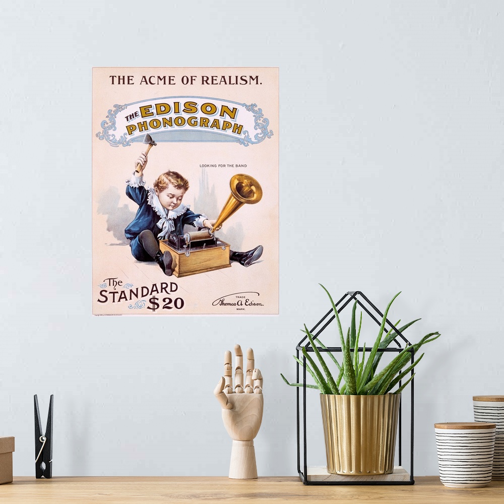 A bohemian room featuring Vintage poster showing a small boy playing with the Edison phonograph.