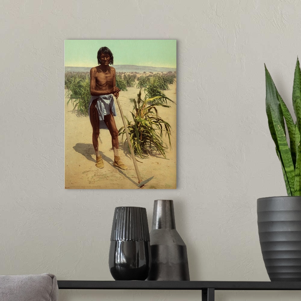 A modern room featuring Hand colored photograph of the man with the hoe.