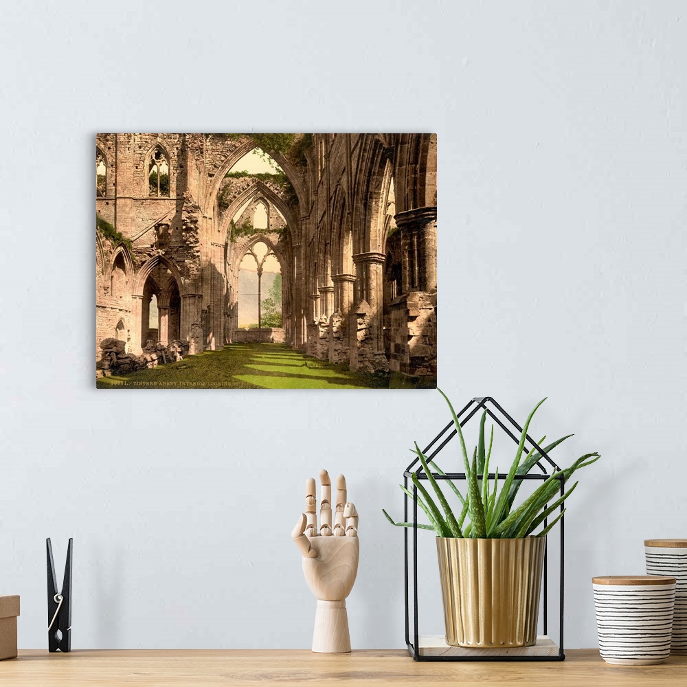 A bohemian room featuring Hand colored photograph of Tintern abbey, England.