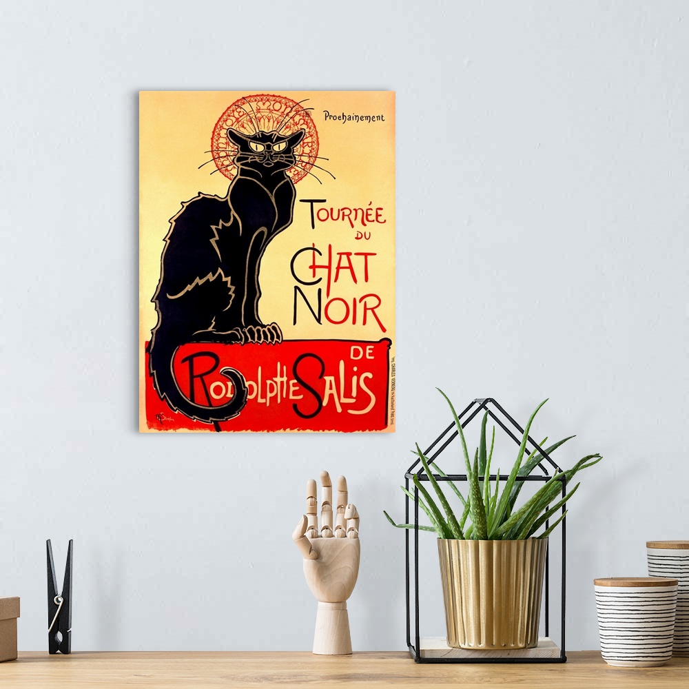 A bohemian room featuring Painting of a large black cat staring at the viewer with text.