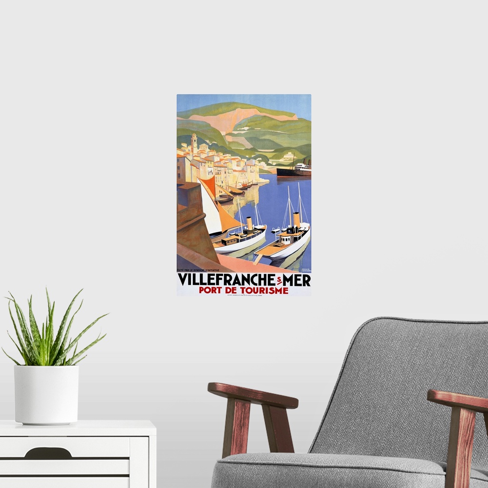 A modern room featuring Large vertical vintage poster showing ships in the water at a port city and large green hills in ...