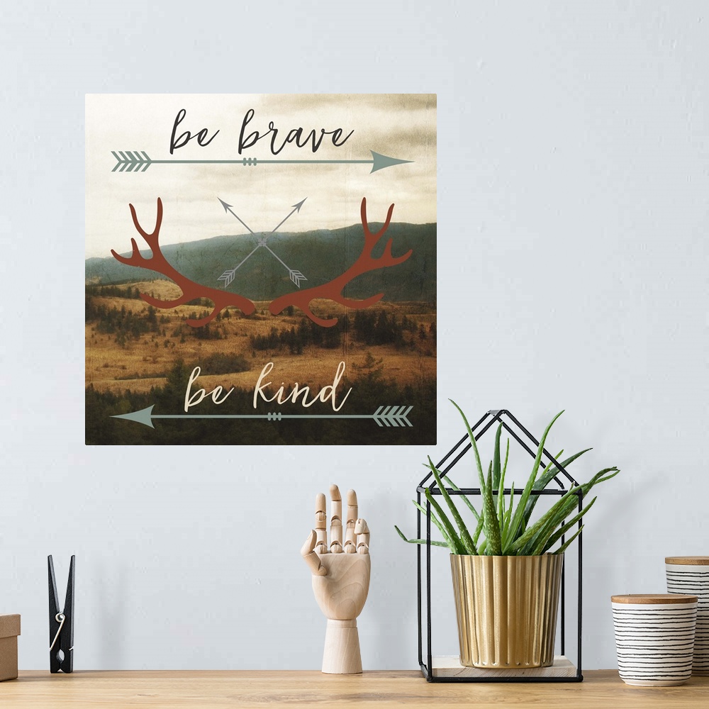 A bohemian room featuring Motivational sentiment with an arrow and antler motif over a landscape image.