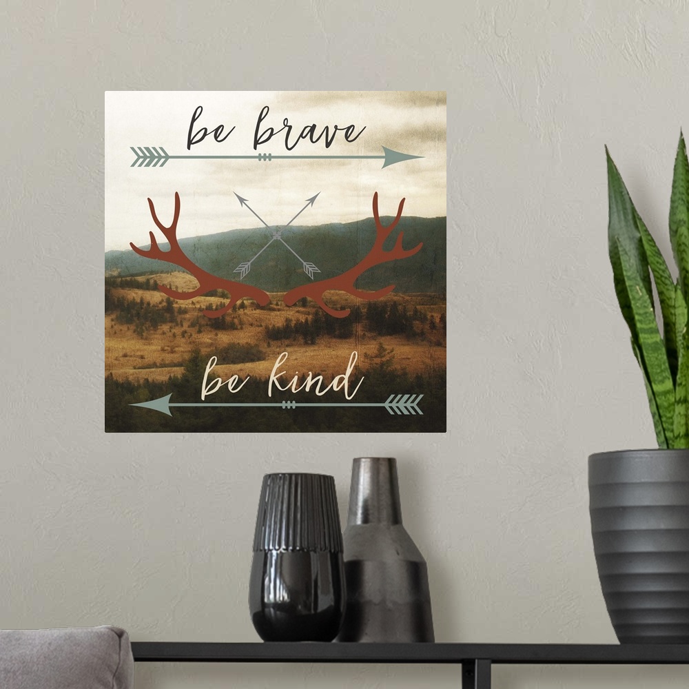 A modern room featuring Motivational sentiment with an arrow and antler motif over a landscape image.