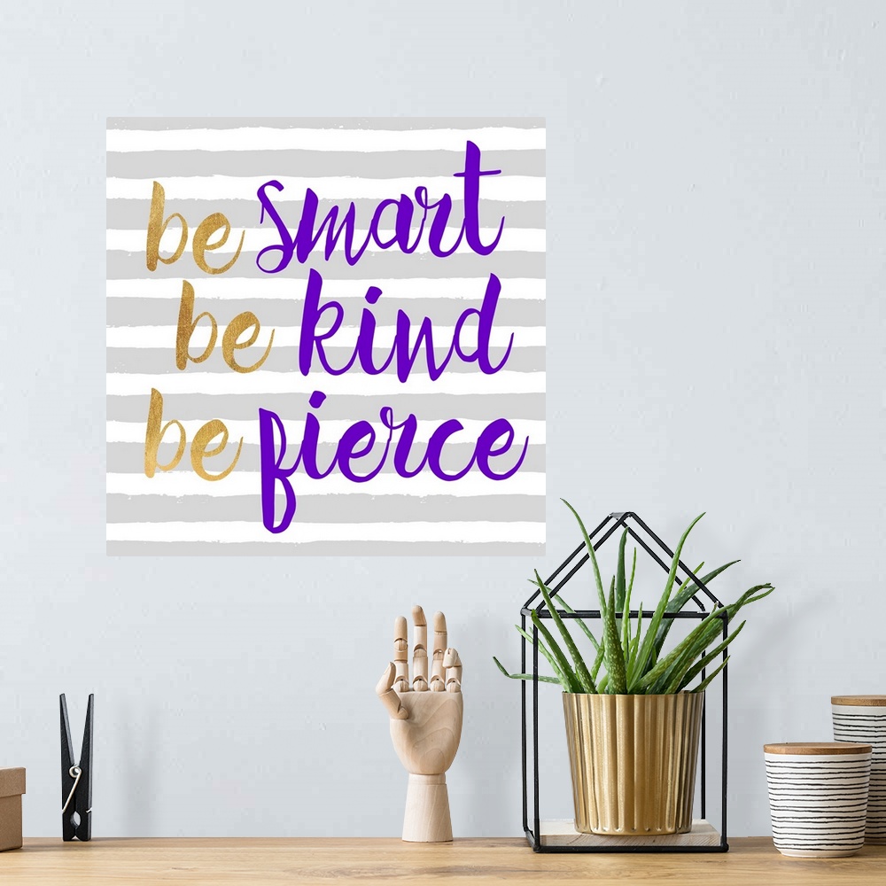 A bohemian room featuring "Be Smart Be Kind Be Fierce" written in purple and gold on a gray and white striped background.