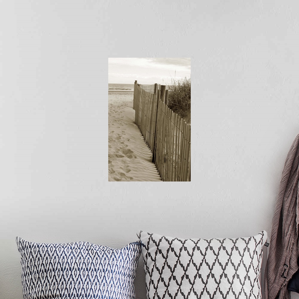 A bohemian room featuring Sepia toned photograph of sand dune fences making a path leading to the beach.