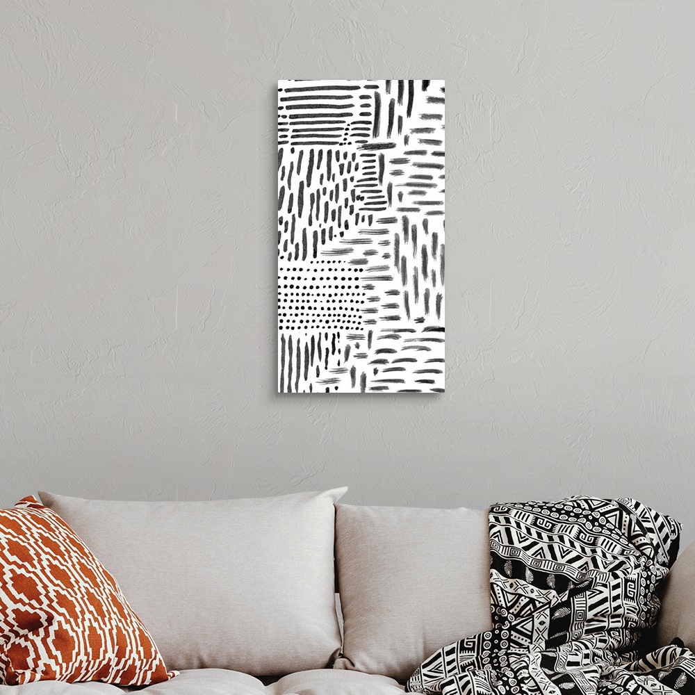 A bohemian room featuring Abstract painting of black marks and streaks on white.