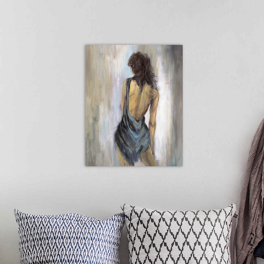 A bohemian room featuring Home decor artwork of a rear view of a woman wearing a blue backless dress.