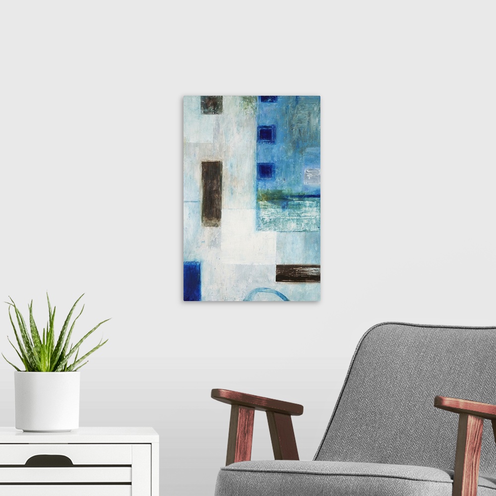 A modern room featuring Abstract geometric artwork in blue tones with black squares.