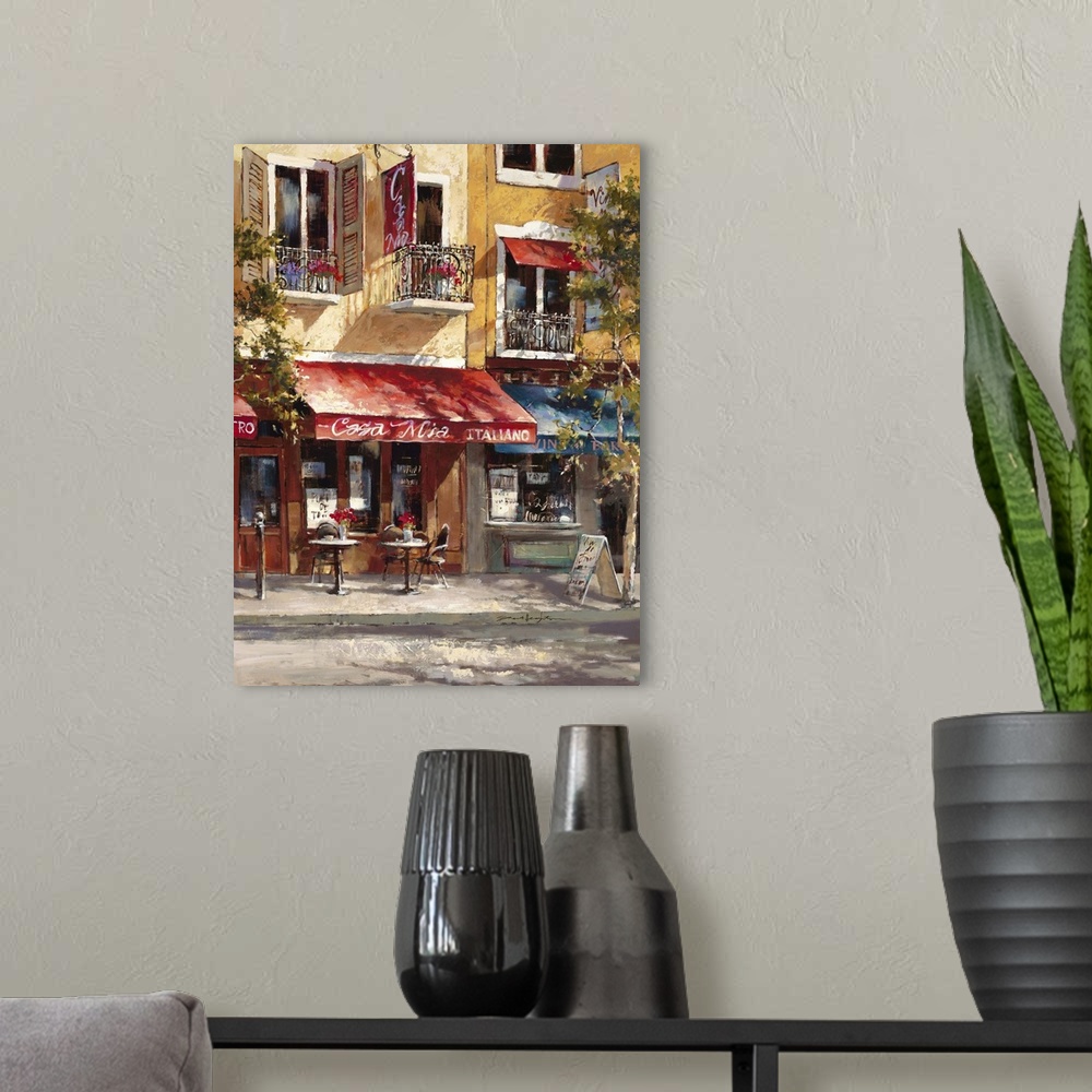 A modern room featuring Contemporary painting of a cafe alongside colorful buildings.