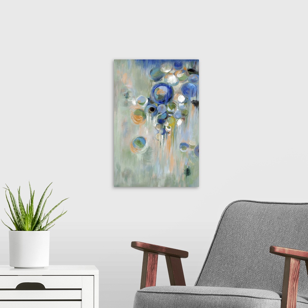 A modern room featuring Home decor abstract artwork of blue circles of different sizes against a pale green background.
