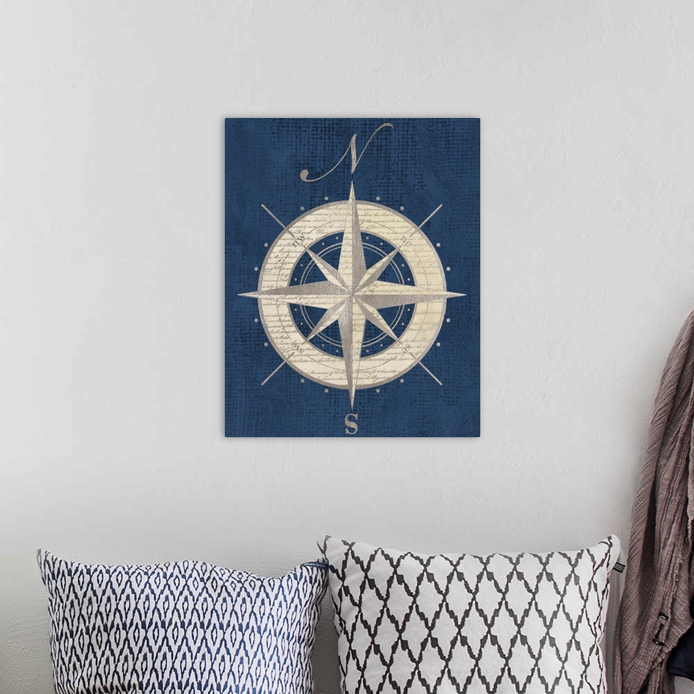A bohemian room featuring Artwork of an antique compass rose representing north and south.