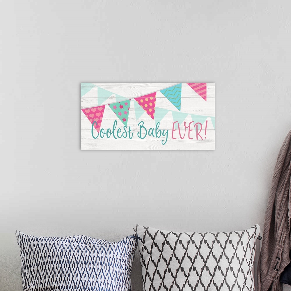A bohemian room featuring "Coolest Baby Ever!" written in blue and pink with banners streaming across the canvas.