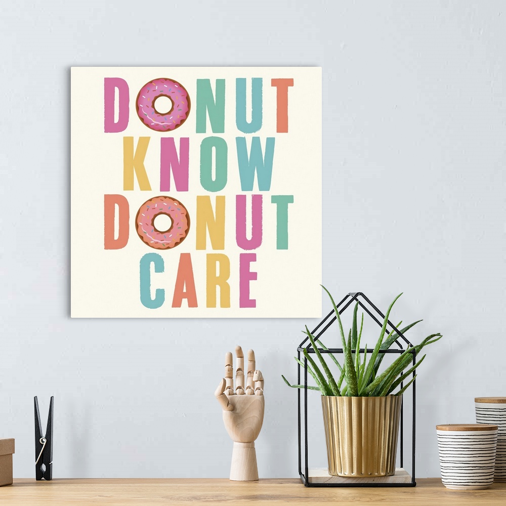 A bohemian room featuring Humorous typography artwork in pastel lettering with a donut motif.