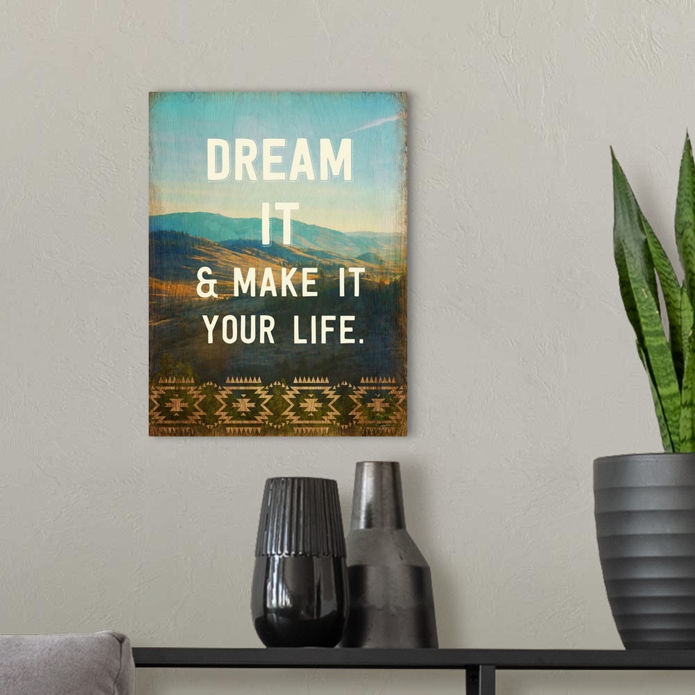 A modern room featuring Contemporary artwork with text over a photograph of a mountainous valley.