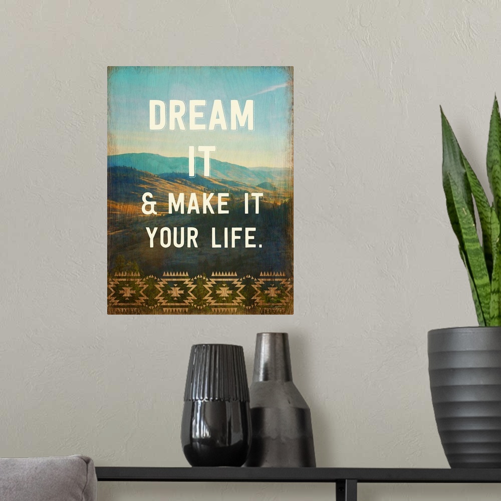 A modern room featuring Contemporary artwork with text over a photograph of a mountainous valley.