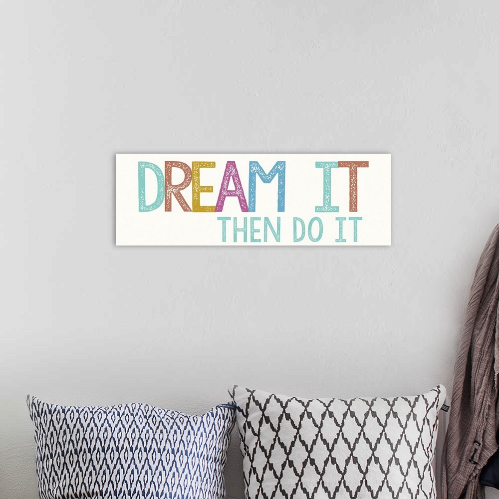 A bohemian room featuring "Dream it, then do it" in bold, colorful letters.